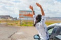 Beautiful woman on her trip by the car. Welcome to Utah road sign. Large welcome sign greets travels in Monument Valley Royalty Free Stock Photo