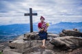 beautiful woman with her typical costume standing on the banks of a large pebble cliff of the hill the hail,