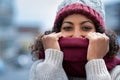 Beautiful woman hiding face in woolen scarf Royalty Free Stock Photo