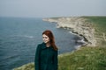 Beautiful woman on a hillside by the sea, wind, smile Royalty Free Stock Photo