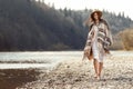 beautiful woman hipster walking on river beach in mountains, having fun and enjoying, boho travel concept, space for text Royalty Free Stock Photo