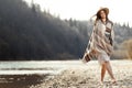 beautiful woman hipster walking on river beach in mountains, having fun and enjoying, boho travel concept, space for text