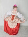 Beautiful woman in historic medieval dress doing curtsy