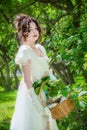 Beautiful woman in an historical bride dress with a wicker basket in her hands Royalty Free Stock Photo