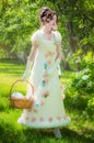 Beautiful woman in an historical bride dress with a wicker basket in her hands Royalty Free Stock Photo
