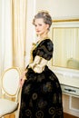 Beautiful woman in historical dress in Baroque style in the inte