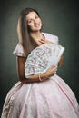 Beautiful woman historical dress with floral fan