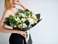 Beautiful woman hold bouquet of chrysanthemum and roses flowers white and purple happy smiling on grey Royalty Free Stock Photo