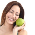 Beautiful woman holding an apple close to her face Royalty Free Stock Photo