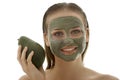 Beautiful woman holding an avocado with green avocado clay facial mask Royalty Free Stock Photo