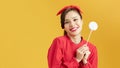 Beautiful woman holding big lollipop candy in hand. Sweet food fun concept Royalty Free Stock Photo