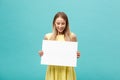 Beautiful woman holding a blank billboard on blue background Royalty Free Stock Photo