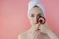 Beautiful woman holding blush brush to apply blush on cheeks on pink background. Copy space Royalty Free Stock Photo