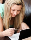 Beautiful woman holding a card using her laptop Royalty Free Stock Photo