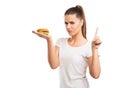 Beautiful woman holding a cheeseburger, saying NO to unhealthy food Royalty Free Stock Photo