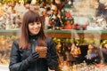 Beautiful woman holding christmas present in front of christmas Royalty Free Stock Photo