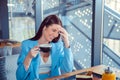 Beautiful woman holding a cup of hot beverage laughing Royalty Free Stock Photo