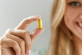 Beautiful Woman Holding Fish Oil Pill In Hand. Healthy Nutrition Royalty Free Stock Photo