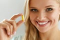 Beautiful Woman Holding Fish Oil Pill In Hand. Healthy Nutrition Royalty Free Stock Photo