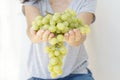 Beautiful woman, holding fresh green grape in hand Royalty Free Stock Photo