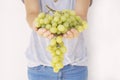 Beautiful woman, holding fresh green grape in hand Royalty Free Stock Photo