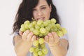 Beautiful woman, holding fresh green grape in hand Royalty Free Stock Photo