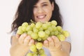 Beautiful woman, holding fresh green grape in hand Royalty Free Stock Photo