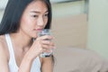 Woman holding a glass of water to drink in bed Royalty Free Stock Photo