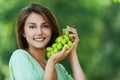 Beautiful woman holding grapes Royalty Free Stock Photo