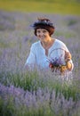 Beautiful woman holding lavender in basket