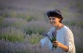 Beautiful woman holding lavender in a field