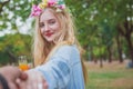 Beautiful woman holding man hand leading in public park in vacation Royalty Free Stock Photo