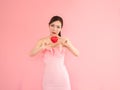 beautiful woman holding mini heart,fashion girl on pink background Royalty Free Stock Photo