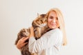 Beautiful woman holding new adopted fluffy cat with green eyes Royalty Free Stock Photo