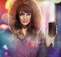 Beautiful lady holding a new smartphone - autumn style commercial