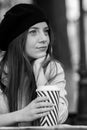 Beautiful woman holding paper coffee cup in the city Young stylish woman drinking coffee to go in a city street Royalty Free Stock Photo