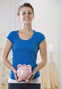 Beautiful woman holding piggy bank. Royalty Free Stock Photo