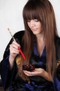 Beautiful woman holding red chopsticks Royalty Free Stock Photo