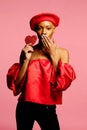 Beautiful woman holding red heart sending kiss