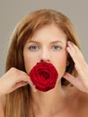 Beautiful woman holding red rose in mouth Royalty Free Stock Photo