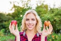 Beautiful woman holding rotten and good apple