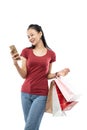 Beautiful woman holding a shopping bag and looking the phone with happiness expression