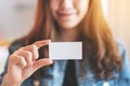 A beautiful woman holding and showing a blank empty business card Royalty Free Stock Photo