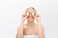 Beautiful woman holding slices of cucumber in front of her eyes Royalty Free Stock Photo