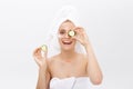 Beautiful woman holding slices of cucumber in front of her eyes Royalty Free Stock Photo