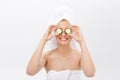 Beautiful woman holding slices of cucumber in front of her eyes Royalty Free Stock Photo