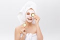 Beautiful woman holding slices of cucumber in front of her eyes Royalty Free Stock Photo