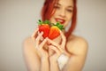 Beautiful woman holding some strawberries in her hands