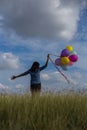 Beautiful woman Holding a transparent ball in the grass field