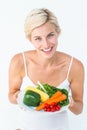 Beautiful woman holding vegetables plate